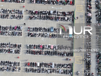 Electric bicycles are being seen at an electric vehicle parking lot near the Suzhou Rail Transit Line 11 Kunshan Huaqiao Station in Suzhou,...