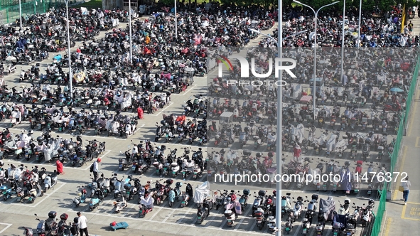 Electric bicycles are being seen at an electric vehicle parking lot near the Suzhou Rail Transit Line 11 Kunshan Huaqiao Station in Suzhou,...