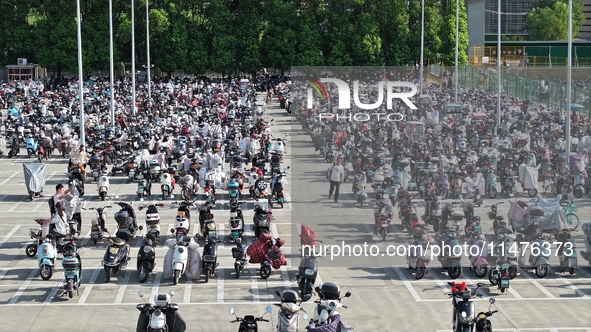 Electric bicycles are being seen at an electric vehicle parking lot near the Suzhou Rail Transit Line 11 Kunshan Huaqiao Station in Suzhou,...