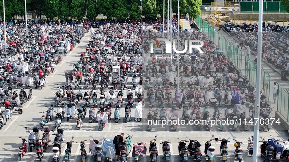 Electric bicycles are being seen at an electric vehicle parking lot near the Suzhou Rail Transit Line 11 Kunshan Huaqiao Station in Suzhou,...