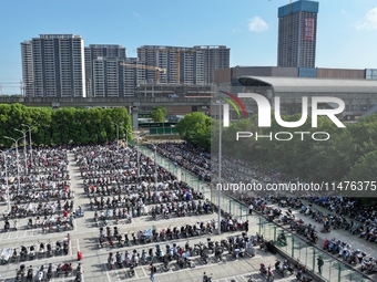 Electric bicycles are being seen at an electric vehicle parking lot near the Suzhou Rail Transit Line 11 Kunshan Huaqiao Station in Suzhou,...