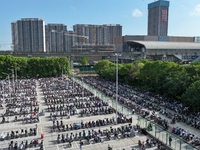 Electric bicycles are being seen at an electric vehicle parking lot near the Suzhou Rail Transit Line 11 Kunshan Huaqiao Station in Suzhou,...