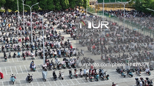 Electric bicycles are being seen at an electric vehicle parking lot near the Suzhou Rail Transit Line 11 Kunshan Huaqiao Station in Suzhou,...