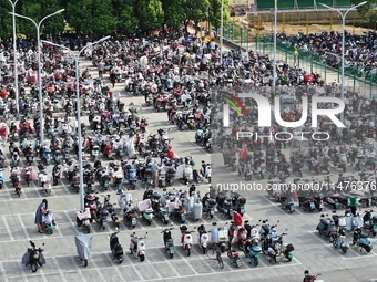 Electric bicycles are being seen at an electric vehicle parking lot near the Suzhou Rail Transit Line 11 Kunshan Huaqiao Station in Suzhou,...