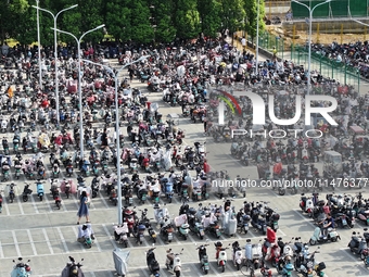 Electric bicycles are being seen at an electric vehicle parking lot near the Suzhou Rail Transit Line 11 Kunshan Huaqiao Station in Suzhou,...