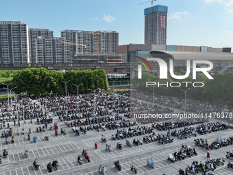 Electric bicycles are being seen at an electric vehicle parking lot near the Suzhou Rail Transit Line 11 Kunshan Huaqiao Station in Suzhou,...