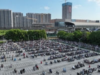 Electric bicycles are being seen at an electric vehicle parking lot near the Suzhou Rail Transit Line 11 Kunshan Huaqiao Station in Suzhou,...