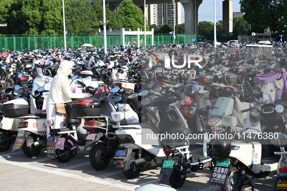 Electric bicycles are being seen at an electric vehicle parking lot near the Suzhou Rail Transit Line 11 Kunshan Huaqiao Station in Suzhou,...