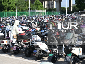 Electric bicycles are being seen at an electric vehicle parking lot near the Suzhou Rail Transit Line 11 Kunshan Huaqiao Station in Suzhou,...