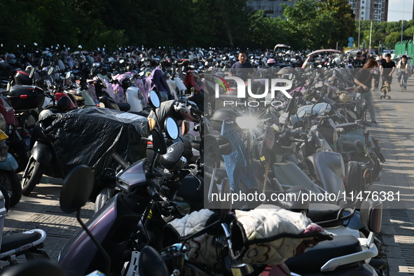 Electric bicycles are being seen at an electric vehicle parking lot near the Suzhou Rail Transit Line 11 Kunshan Huaqiao Station in Suzhou,...