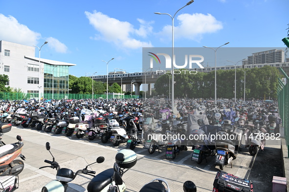 Electric bicycles are being seen at an electric vehicle parking lot near the Suzhou Rail Transit Line 11 Kunshan Huaqiao Station in Suzhou,...