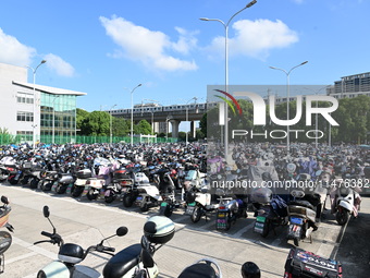 Electric bicycles are being seen at an electric vehicle parking lot near the Suzhou Rail Transit Line 11 Kunshan Huaqiao Station in Suzhou,...