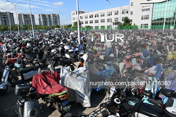 Electric bicycles are being seen at an electric vehicle parking lot near the Suzhou Rail Transit Line 11 Kunshan Huaqiao Station in Suzhou,...