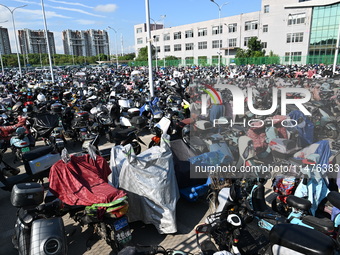 Electric bicycles are being seen at an electric vehicle parking lot near the Suzhou Rail Transit Line 11 Kunshan Huaqiao Station in Suzhou,...