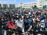 Electric bicycles are being seen at an electric vehicle parking lot near the Suzhou Rail Transit Line 11 Kunshan Huaqiao Station in Suzhou,...