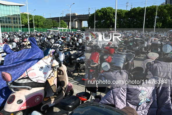 Electric bicycles are being seen at an electric vehicle parking lot near the Suzhou Rail Transit Line 11 Kunshan Huaqiao Station in Suzhou,...