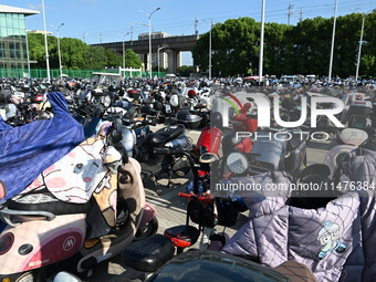 Electric bicycles are being seen at an electric vehicle parking lot near the Suzhou Rail Transit Line 11 Kunshan Huaqiao Station in Suzhou,...