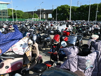 Electric bicycles are being seen at an electric vehicle parking lot near the Suzhou Rail Transit Line 11 Kunshan Huaqiao Station in Suzhou,...