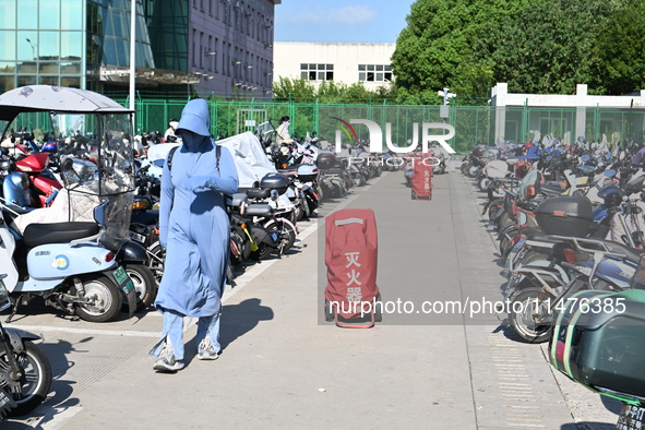 Electric bicycles are being seen at an electric vehicle parking lot near the Suzhou Rail Transit Line 11 Kunshan Huaqiao Station in Suzhou,...