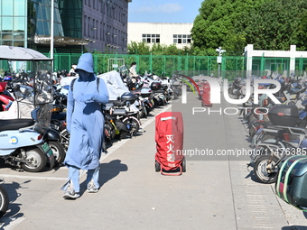 Electric bicycles are being seen at an electric vehicle parking lot near the Suzhou Rail Transit Line 11 Kunshan Huaqiao Station in Suzhou,...