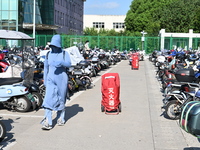 Electric bicycles are being seen at an electric vehicle parking lot near the Suzhou Rail Transit Line 11 Kunshan Huaqiao Station in Suzhou,...