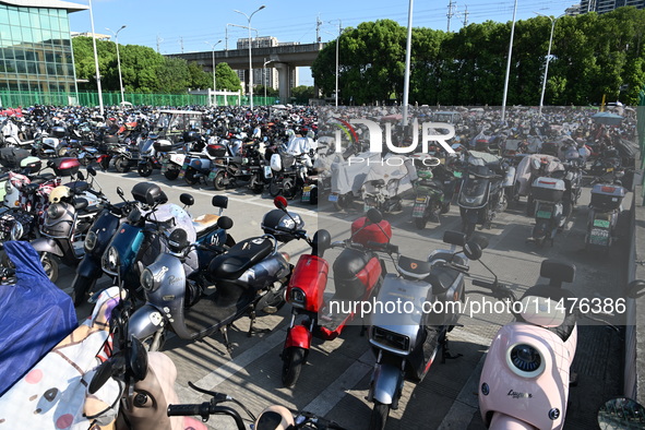 Electric bicycles are being seen at an electric vehicle parking lot near the Suzhou Rail Transit Line 11 Kunshan Huaqiao Station in Suzhou,...