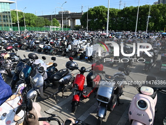 Electric bicycles are being seen at an electric vehicle parking lot near the Suzhou Rail Transit Line 11 Kunshan Huaqiao Station in Suzhou,...