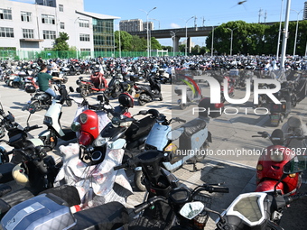 Electric bicycles are being seen at an electric vehicle parking lot near the Suzhou Rail Transit Line 11 Kunshan Huaqiao Station in Suzhou,...