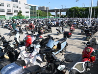 Electric bicycles are being seen at an electric vehicle parking lot near the Suzhou Rail Transit Line 11 Kunshan Huaqiao Station in Suzhou,...