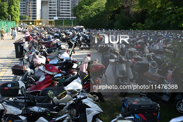 Electric bicycles are being seen at an electric vehicle parking lot near the Suzhou Rail Transit Line 11 Kunshan Huaqiao Station in Suzhou,...