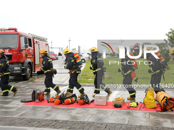 Fire personnel are conducting a firefighting drill at the scene of a high-rise building in Lianyungang, Jiangsu province, China, on August 1...