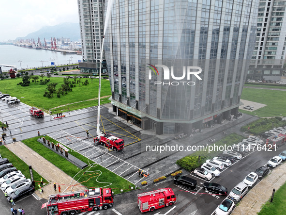 Fire personnel are conducting a firefighting drill at the scene of a high-rise building in Lianyungang, Jiangsu province, China, on August 1...