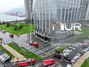 Fire personnel are conducting a firefighting drill at the scene of a high-rise building in Lianyungang, Jiangsu province, China, on August 1...