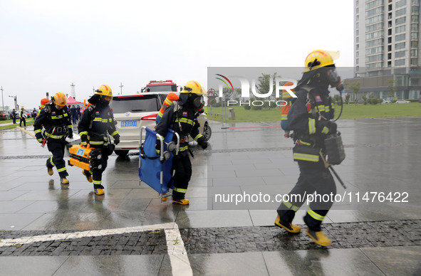 Fire personnel are conducting a firefighting drill at the scene of a high-rise building in Lianyungang, Jiangsu province, China, on August 1...