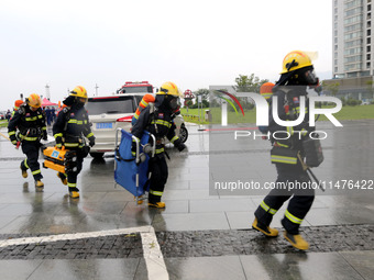 Fire personnel are conducting a firefighting drill at the scene of a high-rise building in Lianyungang, Jiangsu province, China, on August 1...