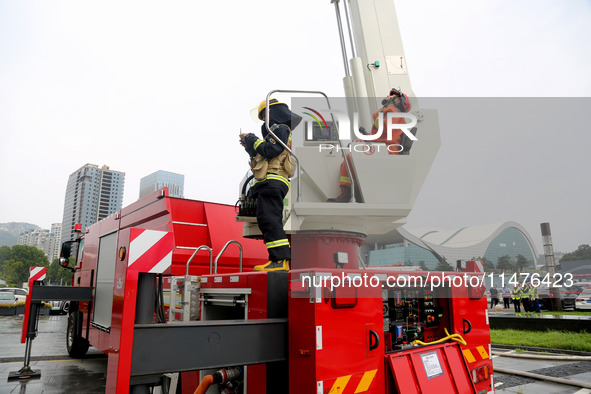 Fire personnel are conducting a firefighting drill at the scene of a high-rise building in Lianyungang, Jiangsu province, China, on August 1...