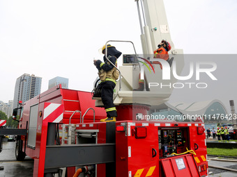 Fire personnel are conducting a firefighting drill at the scene of a high-rise building in Lianyungang, Jiangsu province, China, on August 1...