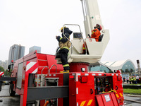 Fire personnel are conducting a firefighting drill at the scene of a high-rise building in Lianyungang, Jiangsu province, China, on August 1...