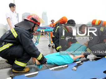 Fire personnel are conducting a firefighting drill at the scene of a high-rise building in Lianyungang, Jiangsu province, China, on August 1...