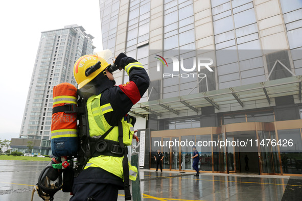 Fire personnel are conducting a firefighting drill at the scene of a high-rise building in Lianyungang, Jiangsu province, China, on August 1...