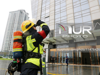 Fire personnel are conducting a firefighting drill at the scene of a high-rise building in Lianyungang, Jiangsu province, China, on August 1...