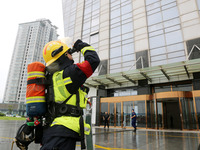 Fire personnel are conducting a firefighting drill at the scene of a high-rise building in Lianyungang, Jiangsu province, China, on August 1...