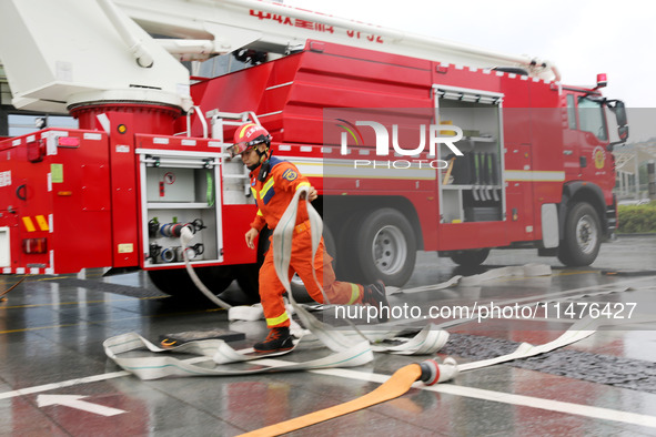 Fire personnel are conducting a firefighting drill at the scene of a high-rise building in Lianyungang, Jiangsu province, China, on August 1...