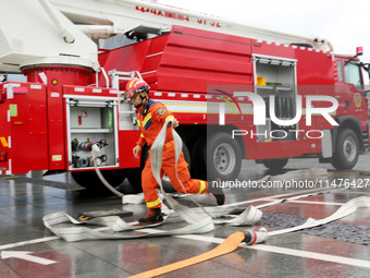 Fire personnel are conducting a firefighting drill at the scene of a high-rise building in Lianyungang, Jiangsu province, China, on August 1...