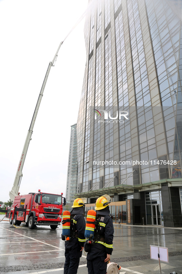 Fire personnel are conducting a firefighting drill at the scene of a high-rise building in Lianyungang, Jiangsu province, China, on August 1...