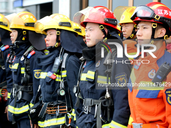 Fire personnel are conducting a firefighting drill at the scene of a high-rise building in Lianyungang, Jiangsu province, China, on August 1...