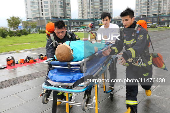 Fire personnel are conducting a firefighting drill at the scene of a high-rise building in Lianyungang, Jiangsu province, China, on August 1...