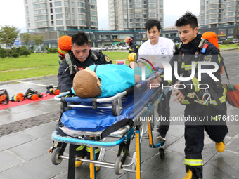 Fire personnel are conducting a firefighting drill at the scene of a high-rise building in Lianyungang, Jiangsu province, China, on August 1...