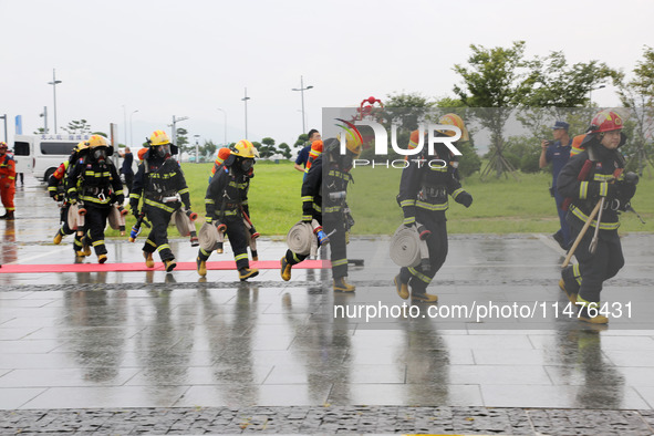 Fire personnel are conducting a firefighting drill at the scene of a high-rise building in Lianyungang, Jiangsu province, China, on August 1...