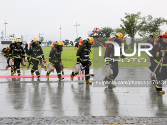 Fire personnel are conducting a firefighting drill at the scene of a high-rise building in Lianyungang, Jiangsu province, China, on August 1...